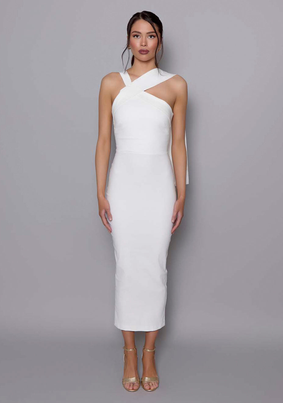 Model wearing the VSPR Everest ivory midaxi dress with sculptural cross-neckline and asymmetric shoulder design, standing against a neutral studio backdrop.