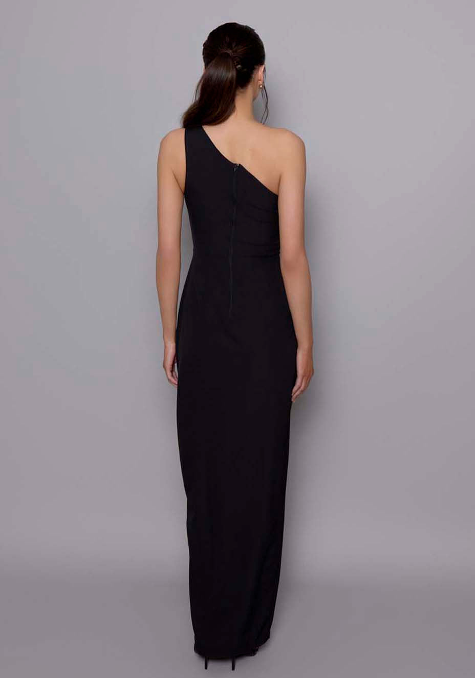 Back view of the VSPR Fliss black satin‑band dress featuring the clean center‑back zip closure, fitted contouring through the waist and hips, and graceful one‑shoulder drape.