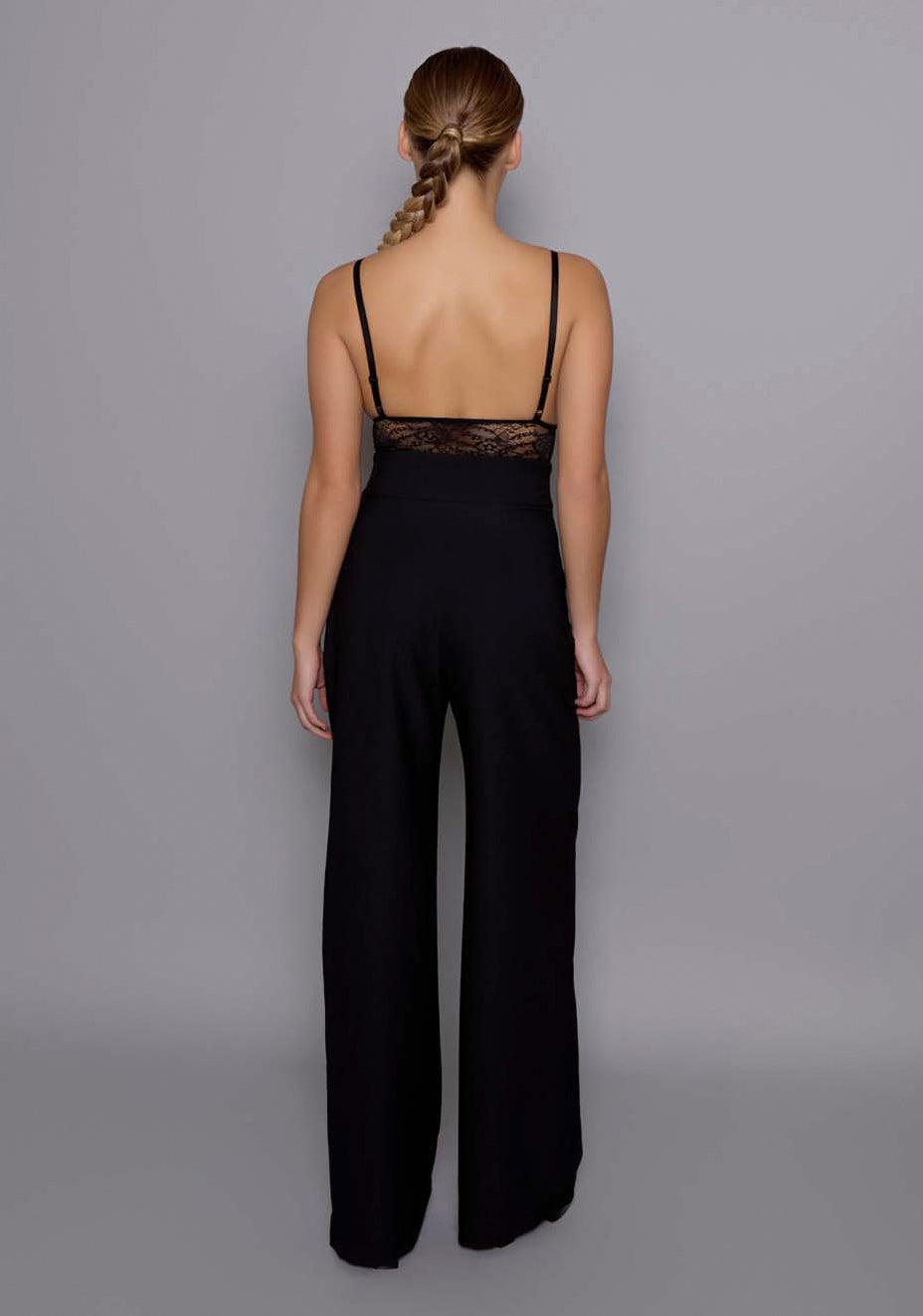Back view of the VSPR Lumi black tailored trousers with a clean silhouette, subtle seam detailing, and a structured fit through the waist and hips.