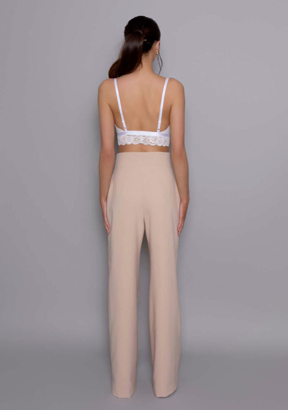 Back view of the VSPR Lumi High-Waist Tailored Trousers showing the clean back closure and sleek, tailored finish, emphasizing the fluid movement of the wide-leg design.