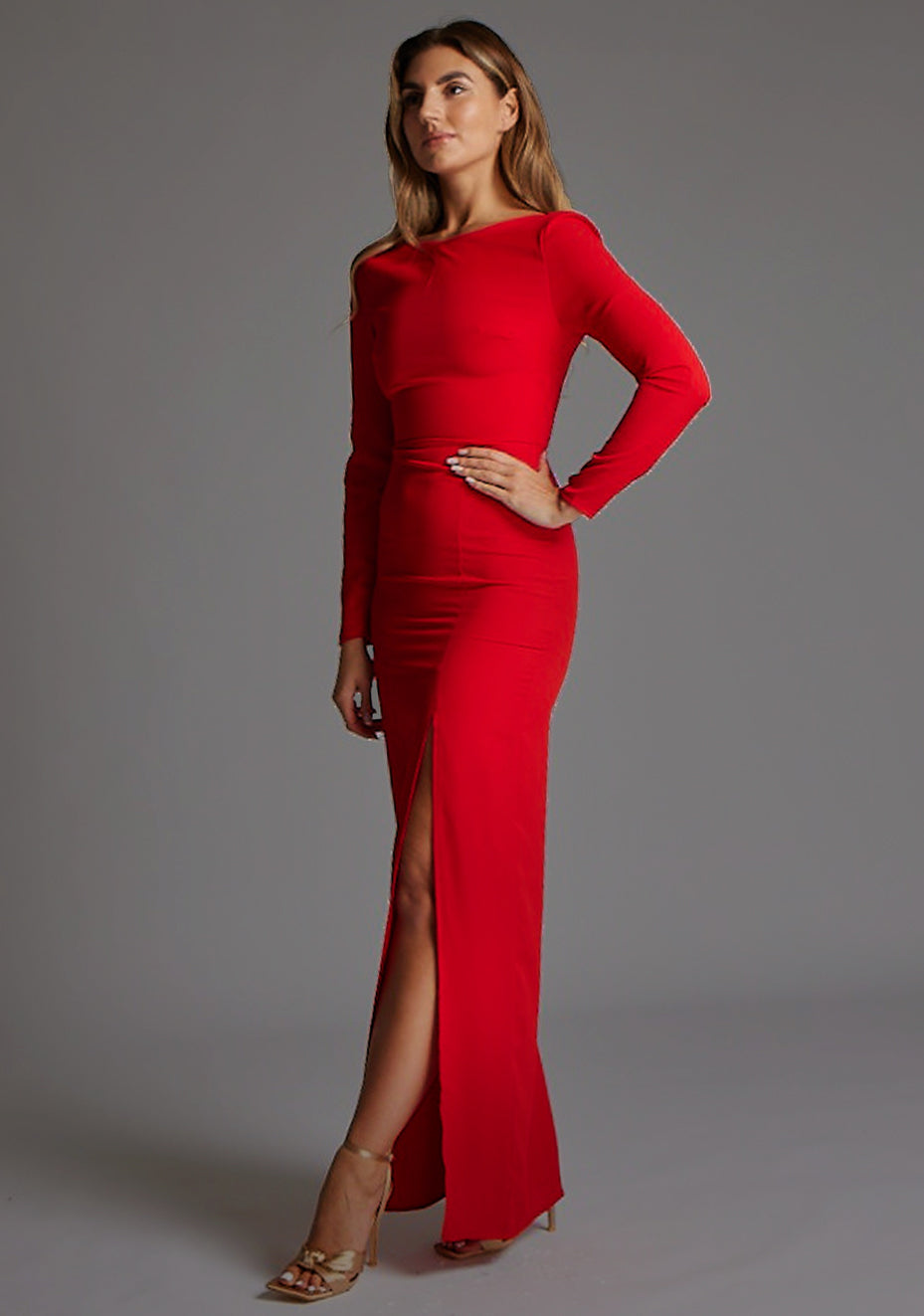 Side front image of a model wearing the Vesper Mandy High Neck Long Sleeve Maxi Dress in Red, emphasizing the smooth contouring fit and graceful floor-length design.