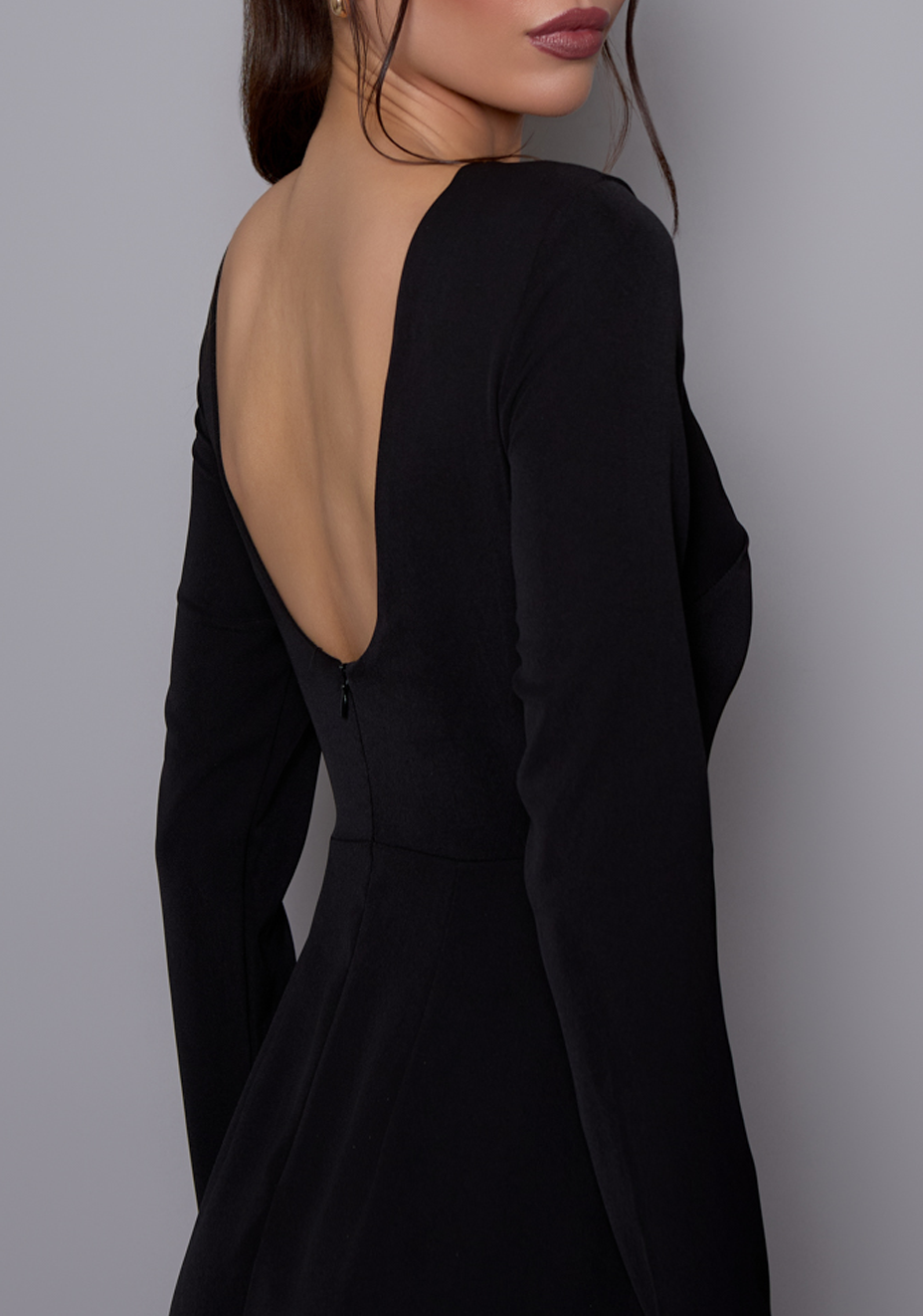 Close-up back angle of the VSPR Mandy dress focusing on the open back curve and smooth transition into the fitted waist and sleeve.