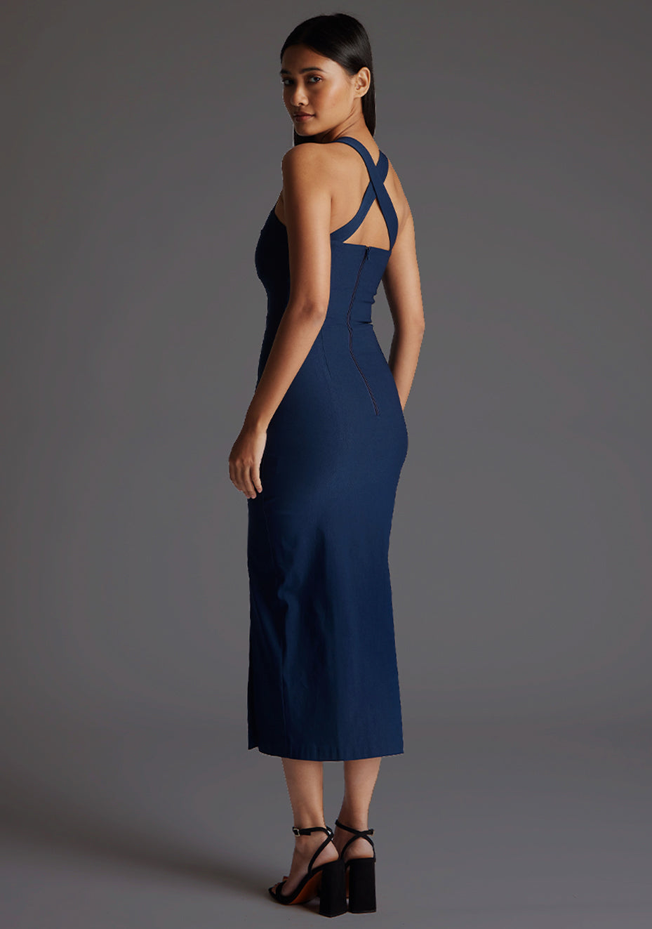 Side back image of a model wearing the Vesper Nellie Notch Neck Midaxi Dress in Navy, displaying the sculpted fit and clean back lines.