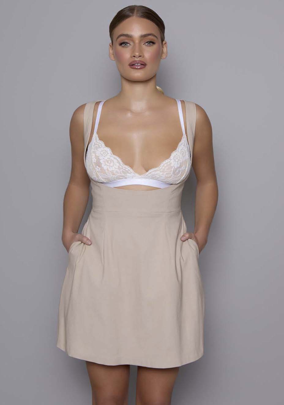 Close-up front of the VSPR Orla dress highlighting the sculpted underlay mini skirt and sheer structured overlay, with visible Celine lace bralette beneath the open bodice, showcasing premium stretch fabric texture.
