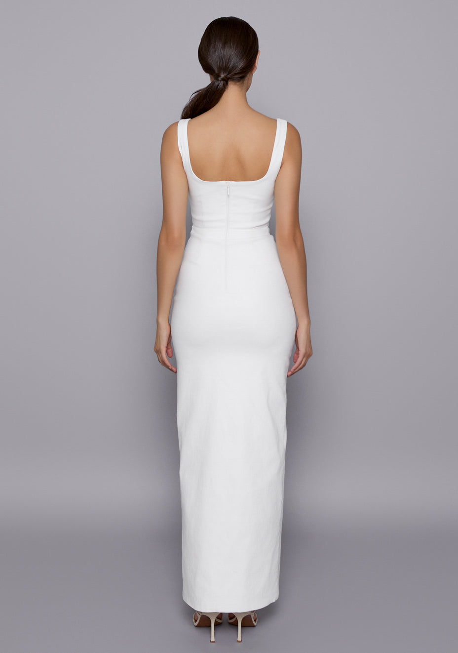 Back view of the VSPR Ria Ivory Dress displaying the wide straps, zip closure, and seamless fit through the back, enhancing the streamlined and polished look.