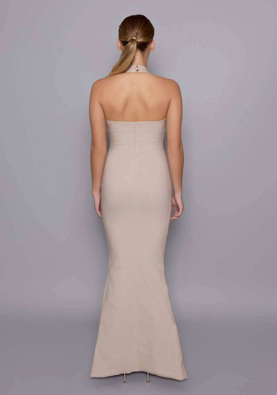 Back view of the VSPR Zara Fishtail Maxi Dress, emphasizing the clean lines, halter straps, and graceful fishtail design that hugs the body beautifully.