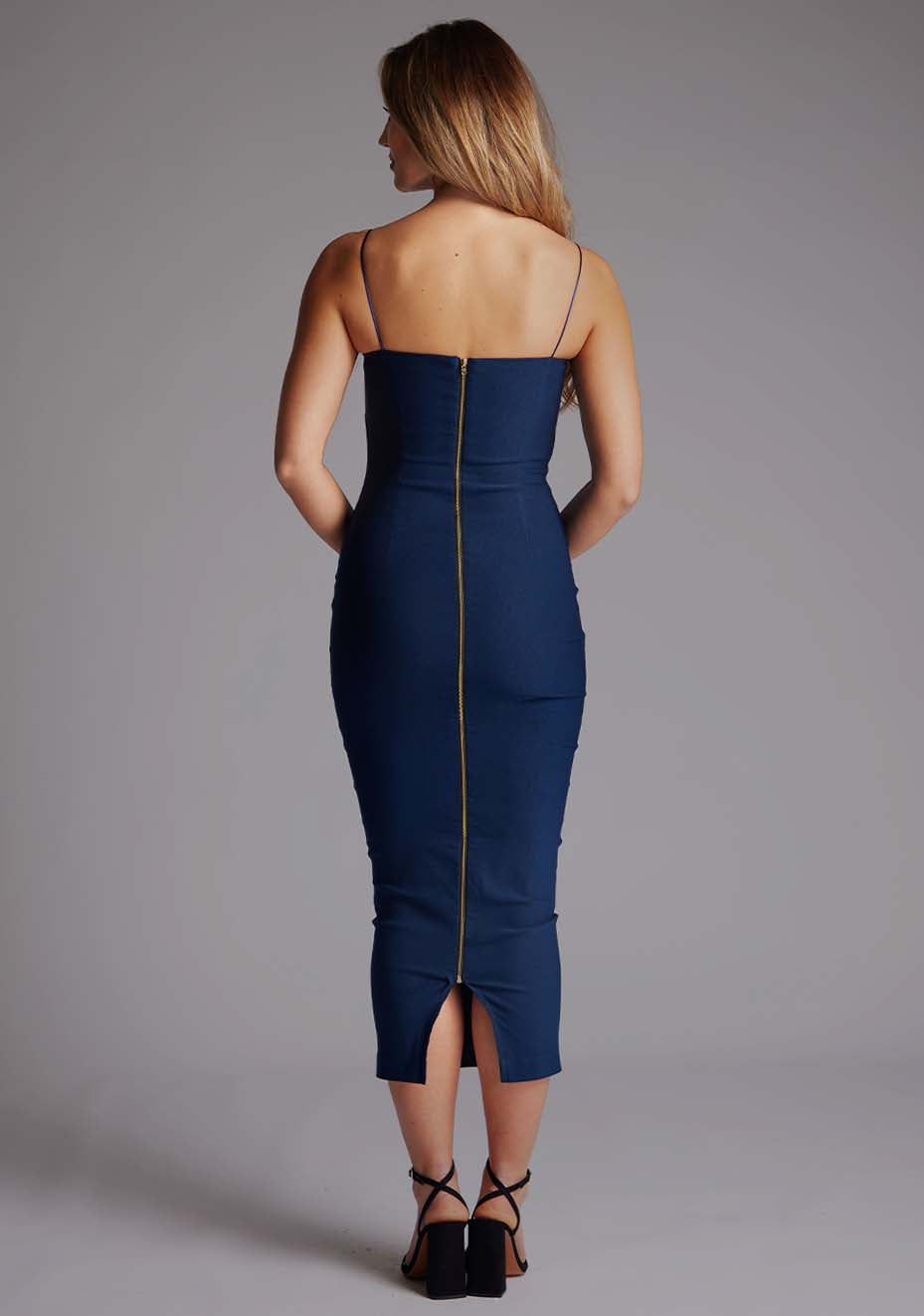 Back image of a model wearing the Vesper Zendeya Scoop Neckline Midaxi Dress in Navy with slim spaghetti straps and a clean, minimalist back profile.