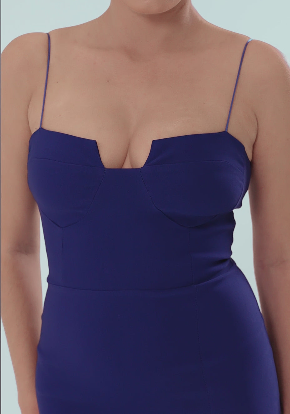 Model posing and turning in the VSPR Suki Cup Detail Maxi Dress in cobalt blue, showcasing the chic straight neckline with front cut-out, delicate thin straps, and flowing maxi length. The captivating cobalt color and modern fit highlight the dress’s elegance as the model moves gracefully in a studio setting. Close-up clips reveal the back zip closure and fine fabric detail.